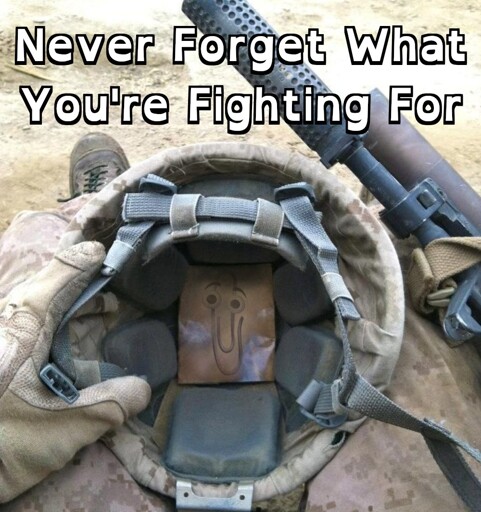 POV: A Soldier Looking at a Photo of Clippy Inside a Helmet